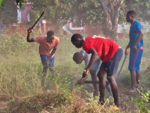 Young people working on field in Bolama.